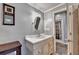 Bathroom with a decorative framed mirror and vanity with off-white cabinets at 2875 Daniel Park Run, Dacula, GA 30019
