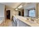 Bright bathroom featuring double sinks, tile flooring, and large vanity mirror at 2875 Daniel Park Run, Dacula, GA 30019