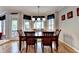 Dining room area with wooden table and chairs and bright windows overlooking the yard at 2875 Daniel Park Run, Dacula, GA 30019