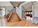 Spacious entryway with hardwood floors, staircase, chandelier, and view to adjacent sitting and front room at 2875 Daniel Park Run, Dacula, GA 30019