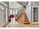 Grand entryway with hardwood floors, staircase, high ceilings, chandelier, and view to adjacent front room at 2875 Daniel Park Run, Dacula, GA 30019