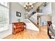 Elegant entryway with hardwood floors, staircase, chandelier, and view to the dining room at 2875 Daniel Park Run, Dacula, GA 30019