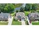 Aerial view of well-kept, blue, two-story home with beautiful lawn that backs up to a pond in a lovely neighborhood at 2875 Daniel Park Run, Dacula, GA 30019