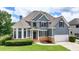 Stunning two-story home with beautiful blue siding, stone accents, manicured lawn, and a two-car garage at 2875 Daniel Park Run, Dacula, GA 30019