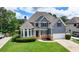 Beautiful two-story home with lush green lawn, stone accents, blue siding and an attached two-car garage at 2875 Daniel Park Run, Dacula, GA 30019
