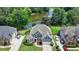 Aerial view of a beautiful home with lush front yard landscaping and a serene pond nearby at 2875 Daniel Park Run, Dacula, GA 30019