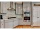 Well-lit kitchen with stainless steel appliances, stone countertops and wooden floors at 2875 Daniel Park Run, Dacula, GA 30019