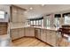 Spacious kitchen with wooden floors, stone countertops and stainless steel dishwasher and sink at 2875 Daniel Park Run, Dacula, GA 30019