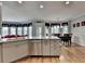 This kitchen overlooks the dining area and features wood floors, stone countertops and stainless appliances at 2875 Daniel Park Run, Dacula, GA 30019