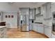 This kitchen features wood floors, stone countertops, stainless appliances and lots of cabinet space at 2875 Daniel Park Run, Dacula, GA 30019