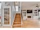 Inviting living room featuring hardwood floors, fireplace, built-in shelving, and a staircase at 2875 Daniel Park Run, Dacula, GA 30019