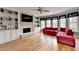 Bright living room boasts hardwood floors, a stone fireplace, custom built-ins, and natural light at 2875 Daniel Park Run, Dacula, GA 30019