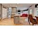 Open floor plan with combined living, dining and kitchen areas and wooden floors at 2875 Daniel Park Run, Dacula, GA 30019