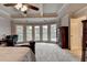 Main bedroom with large windows, coffered ceilings and natural light, enhancing the room's openness and appeal at 2875 Daniel Park Run, Dacula, GA 30019