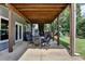 Covered outdoor patio with dining set and stairs to the backyard and playground at 2875 Daniel Park Run, Dacula, GA 30019