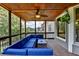 Relaxing screened porch with stylish furniture, a ceiling fan, wood ceiling and a mounted TV for outdoor entertainment at 2875 Daniel Park Run, Dacula, GA 30019