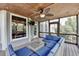 Comfortable screened porch with stylish furniture, ceiling fan, and views of the well-manicured backyard at 2875 Daniel Park Run, Dacula, GA 30019