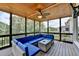 Comfortable screened porch with a wicker sofa, ceiling fan, and wood ceiling perfect for enjoying the outdoors at 2875 Daniel Park Run, Dacula, GA 30019