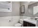 Elegant half-bath featuring stylish fixtures, a dark wood vanity, and attractive wainscoting at 1604 Gilstrap Nw Ln, Atlanta, GA 30318