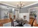 Open concept dining room with hardwood floors, modern lighting, and adjacent staircase at 1604 Gilstrap Nw Ln, Atlanta, GA 30318