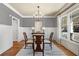 Chic dining room with hardwood flooring, a modern chandelier, and large window for ample light at 1604 Gilstrap Nw Ln, Atlanta, GA 30318