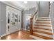 Bright foyer featuring hardwood floors, a staircase, and a charming entry door with sidelights at 1604 Gilstrap Nw Ln, Atlanta, GA 30318
