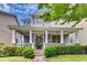 Charming two-story home with a welcoming front porch, stone accents, and beautiful landscaping at 1604 Gilstrap Nw Ln, Atlanta, GA 30318
