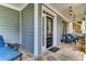 Inviting front porch with stone flooring, comfortable seating, and decorative hanging lanterns at 1604 Gilstrap Nw Ln, Atlanta, GA 30318