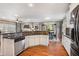 Bright, spacious kitchen with stainless steel appliances, a breakfast bar, and hardwood floors at 1604 Gilstrap Nw Ln, Atlanta, GA 30318