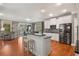 Open kitchen with stainless steel appliances, center island with seating, and adjacent seating area at 1604 Gilstrap Nw Ln, Atlanta, GA 30318