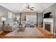 Cozy living room with fireplace, plush seating, and ample natural light from the large windows at 1604 Gilstrap Nw Ln, Atlanta, GA 30318
