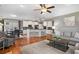 Open-concept living space with hardwood floors, modern furnishings, and a seamless flow into the kitchen and dining area at 1604 Gilstrap Nw Ln, Atlanta, GA 30318