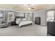 Spacious main bedroom featuring plush carpeting, a tray ceiling, and ample natural light from the windows at 1604 Gilstrap Nw Ln, Atlanta, GA 30318