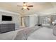 Serene main bedroom with tray ceilings, a barn door to the ensuite, and a comfortable sitting area at 1604 Gilstrap Nw Ln, Atlanta, GA 30318