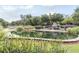 Picturesque pond with stone edging, a bridge, fireplace, and bench seating set in a serene park-like community at 1604 Gilstrap Nw Ln, Atlanta, GA 30318