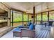 Relaxing screened porch with outdoor fireplace, comfortable seating, and a view of the backyard at 1604 Gilstrap Nw Ln, Atlanta, GA 30318