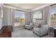 Bright and airy sitting room with comfortable seating, large windows, and elegant decor at 1604 Gilstrap Nw Ln, Atlanta, GA 30318