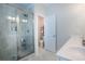 Bright bathroom featuring a glass-enclosed shower, tile surround, and ample vanity space at 2247 Pink Hawthorn Dr, Buford, GA 30518