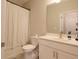 Clean bathroom showcasing a tub with shower curtain, white vanity, and soft, neutral wall color at 2247 Pink Hawthorn Dr, Buford, GA 30518