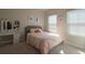 Bright bedroom with a modern vanity, large windows, and neutral décor at 2247 Pink Hawthorn Dr, Buford, GA 30518