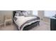 Cozy bedroom with a made bed, plush pillows, neutral carpet, and bright natural light at 2247 Pink Hawthorn Dr, Buford, GA 30518