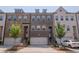 Charming brick townhome with a two-car garage and well-maintained landscaping in a private residence at 2247 Pink Hawthorn Dr, Buford, GA 30518
