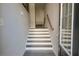 Bright foyer with white trim stairs, gray wood flooring, and a modern design at 2247 Pink Hawthorn Dr, Buford, GA 30518