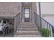 Welcoming entryway with brick steps, decorative lanterns, and a secure front door at 2247 Pink Hawthorn Dr, Buford, GA 30518