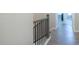 Hallway with hardwood flooring and decorative black wrought iron spindles on staircase at 2247 Pink Hawthorn Dr, Buford, GA 30518