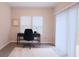 Bright home office featuring wood-look floors, black desk, neutral paint, and sliding glass door to a deck at 2247 Pink Hawthorn Dr, Buford, GA 30518