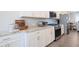 Close-up of kitchen featuring white cabinets, granite countertops, and stainless steel appliances at 2247 Pink Hawthorn Dr, Buford, GA 30518