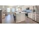 Contemporary kitchen with white cabinets, stainless appliances, and an island with barstool seating at 2247 Pink Hawthorn Dr, Buford, GA 30518