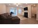 Comfortable living area with modern fireplace, gray sofa, and an open floor plan at 2247 Pink Hawthorn Dr, Buford, GA 30518