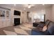 Spacious living room with a fireplace, built-in shelving, and open layout to the kitchen at 2247 Pink Hawthorn Dr, Buford, GA 30518